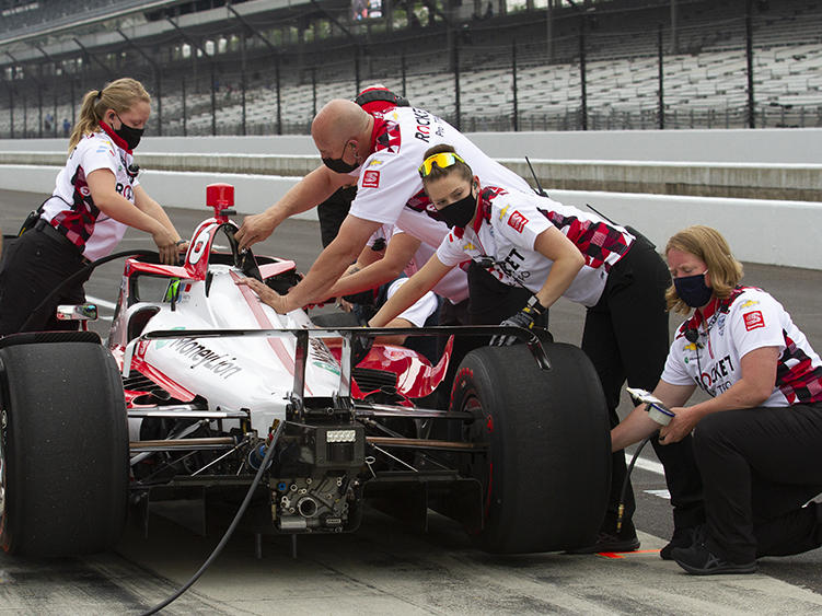 Paretta Autosport crew members work on their car in pit lane at the Indianapolis Motor Speedway during a practice session earlier this week. It could become the first majority-women team to qualify for the Indy 500. DOUG JAGGERS / WFYI