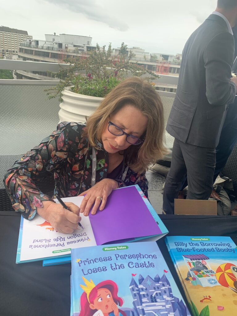 Former FDIC Chair Sheila Bair signs books from her children's series, Money Tales